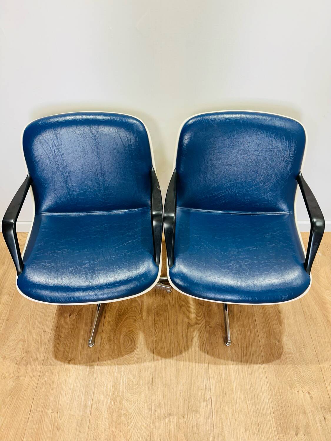 2 office chairs attr. to Strafor, white molded plastic shell, blue skai and chrome metal star base