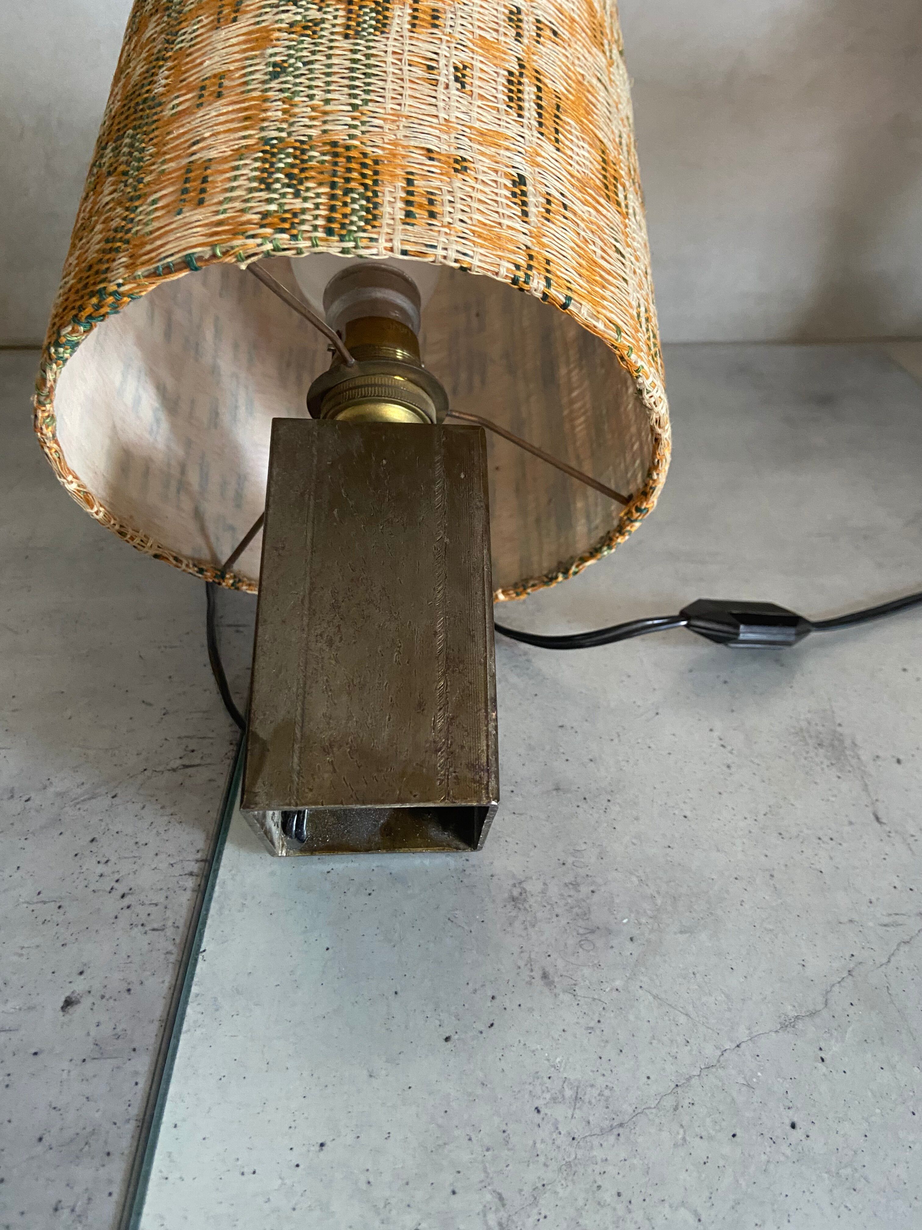Small modernist table lamp with hand-woven shade.
