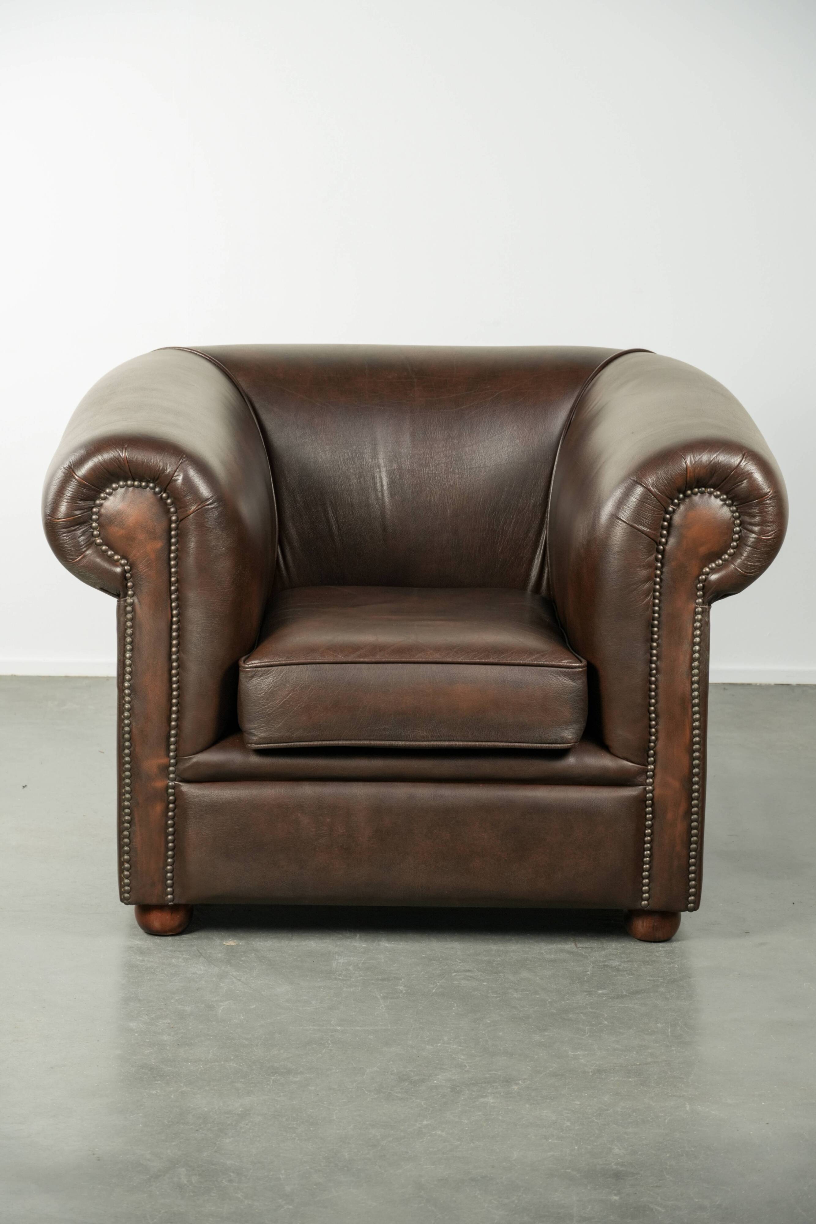 Set of a smooth chesterfield sofa and armchair with a timeless English look