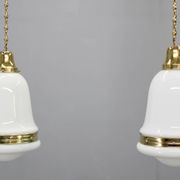 Pair of 1930s Peter Behrens Luzette pendants in opaline glass and brass