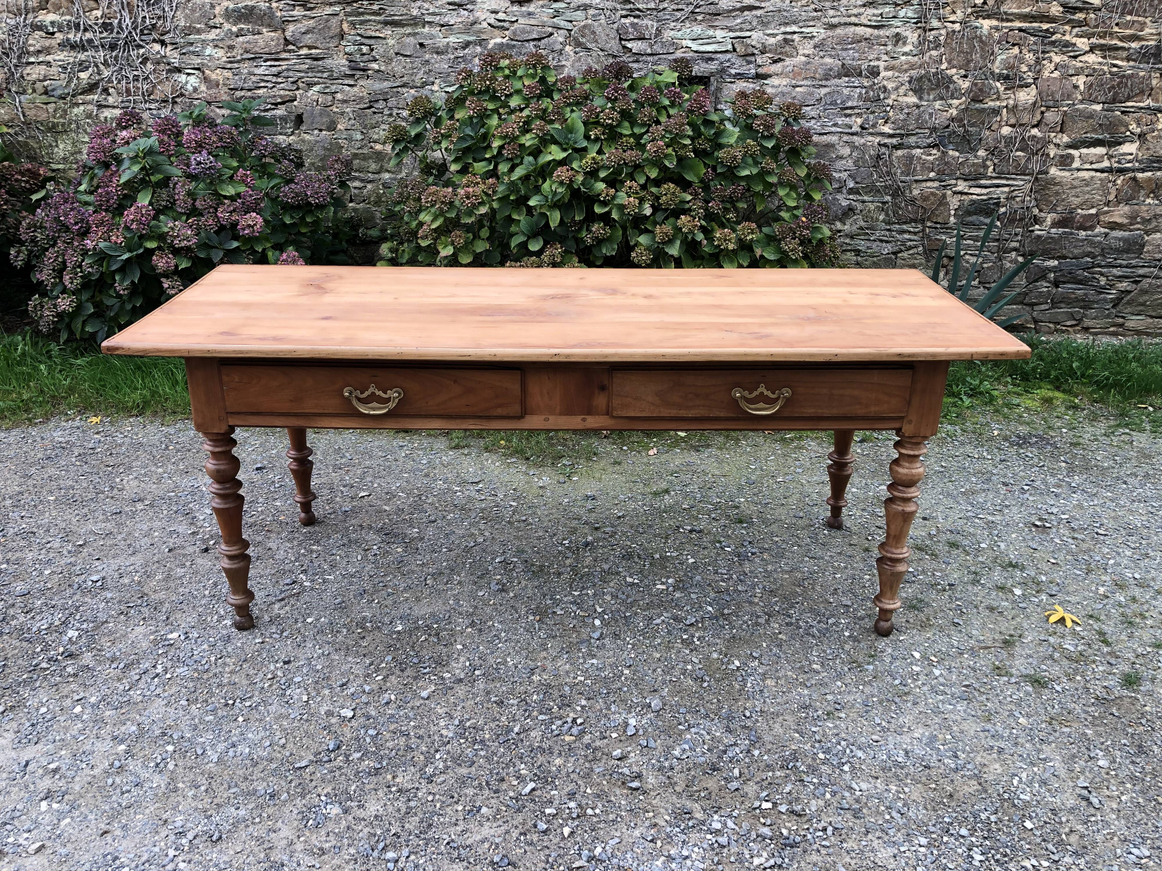 Antique Louis Philippe style farm table in solid cherry wood with 2 drawers and turned base.