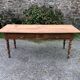 Antique Louis Philippe style farm table in solid cherry wood with 2 drawers and turned base.
