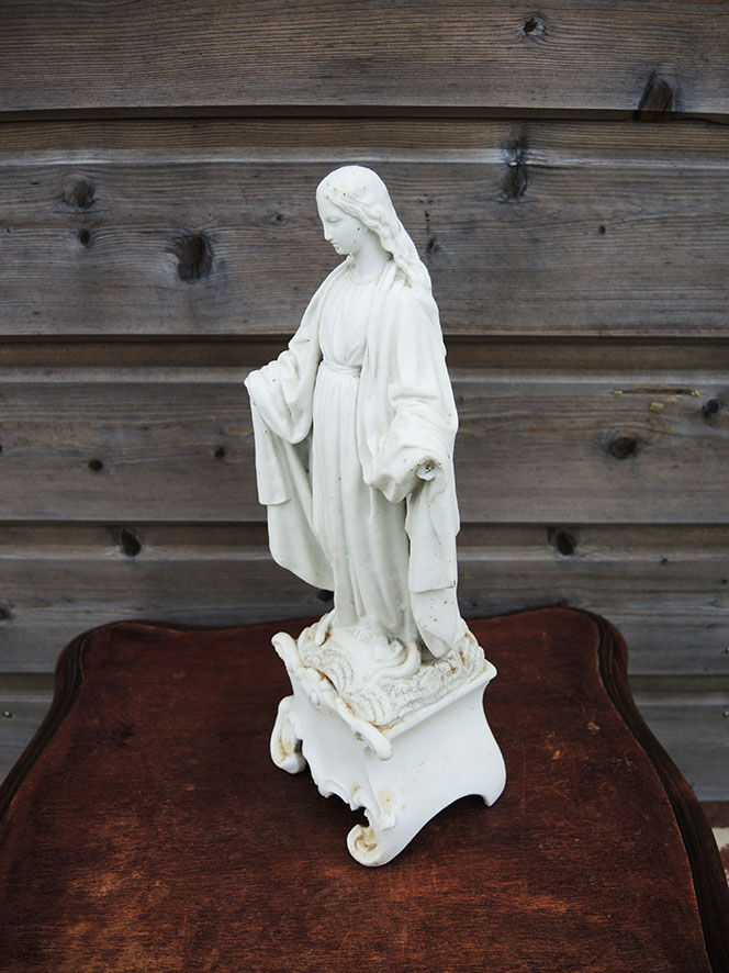 Ancient statuette of the virgin with the serpent in biscuit