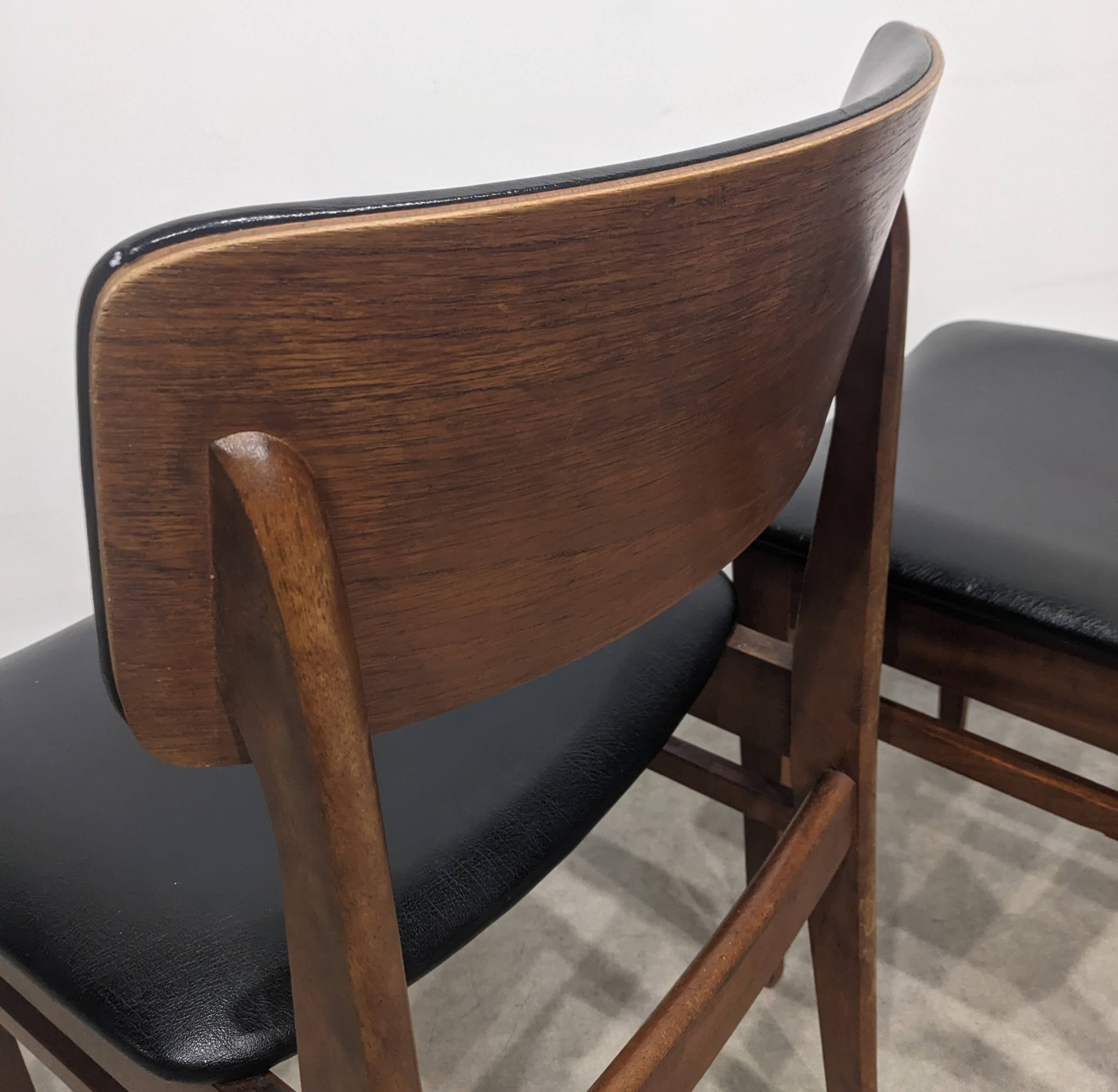 Two mid-century faux leather chairs