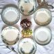 Mismatched antique flat plates made of ironstone pottery.