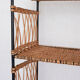 Woven rattan shelf and black metal