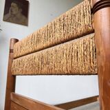 Brutalist style bed with chain and straw