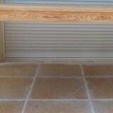 Large natural wood table with rectangular top supported by legs