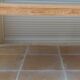 Large natural wood table with rectangular top supported by legs