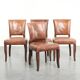 Set of 4 cognac-coloured cowleather dining chairs with decorative nails