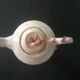 Vintage teapot with relief coral decoration.