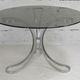 Table de séjour "Space Age" acier poli, dalle circulaire verre fumé. France, circa 1970.