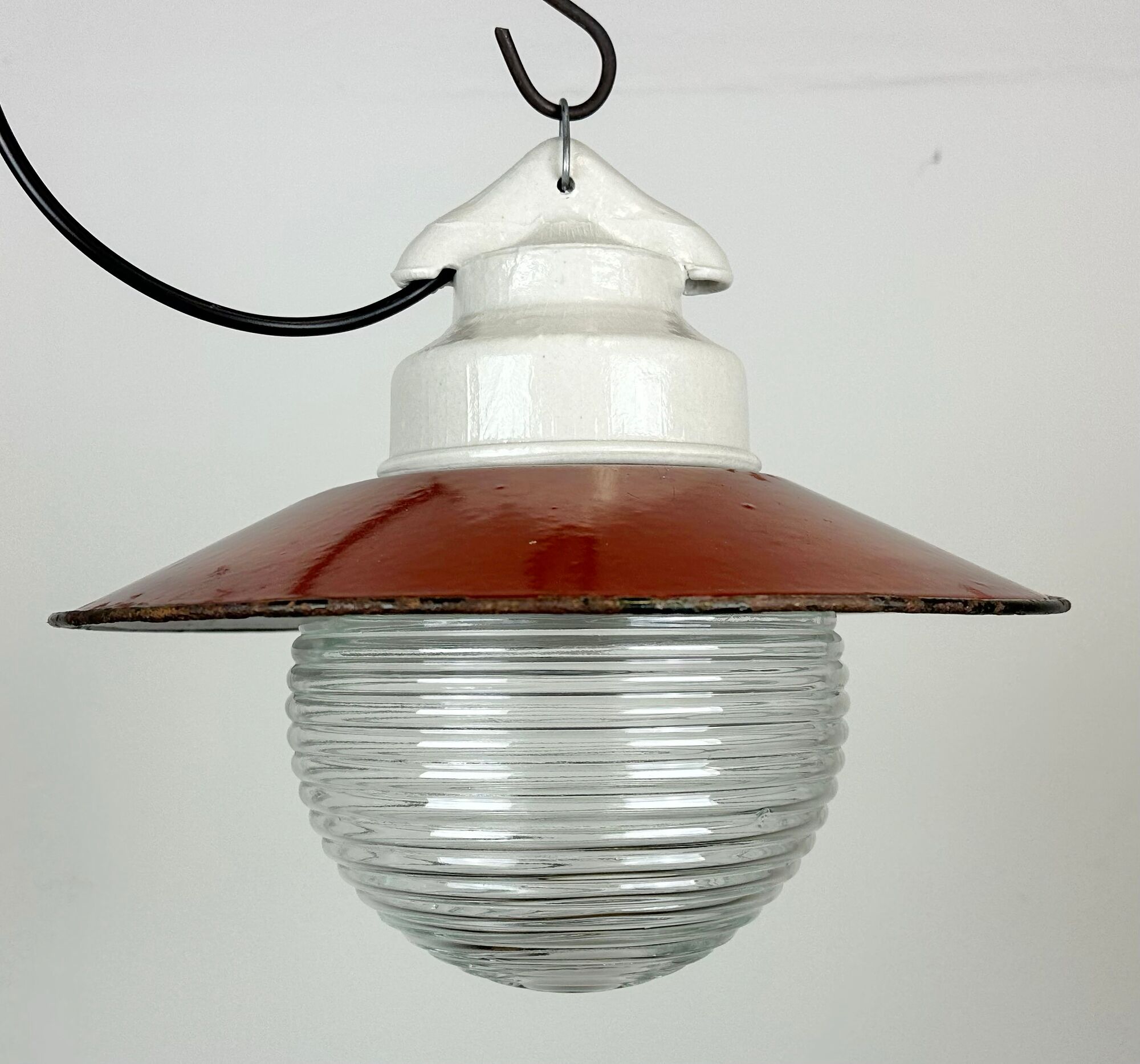 Industrial porcelain red enamel pendant light with ribbed clear glass, 1970s