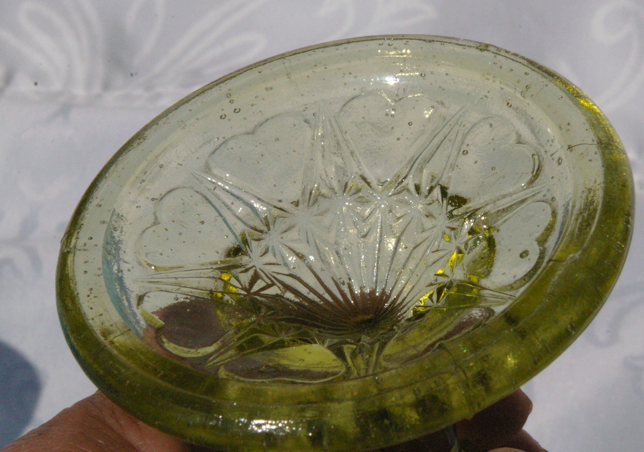 Old small cut on foot in yellow molded glass