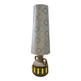 Vintage ceramic floor lamp with illuminated base.