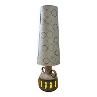 Vintage ceramic floor lamp with illuminated base.