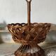 Wicker fruit bowl on a stand