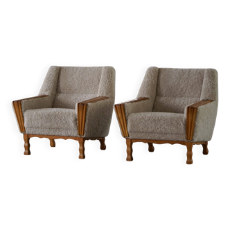 Modern Danish, a pair of easy chairs in oak and lamb's wool, Henning Kjærnulf, 1960s.