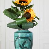 Chinese glazed earthenware vase with bird and flower decoration on a green background