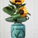 Chinese glazed earthenware vase with bird and flower decoration on a green background