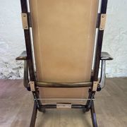 Colonial style leather armchair and ottoman