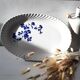 Keller and Guérin Lunéville serving dish with blue flowers on a white background.