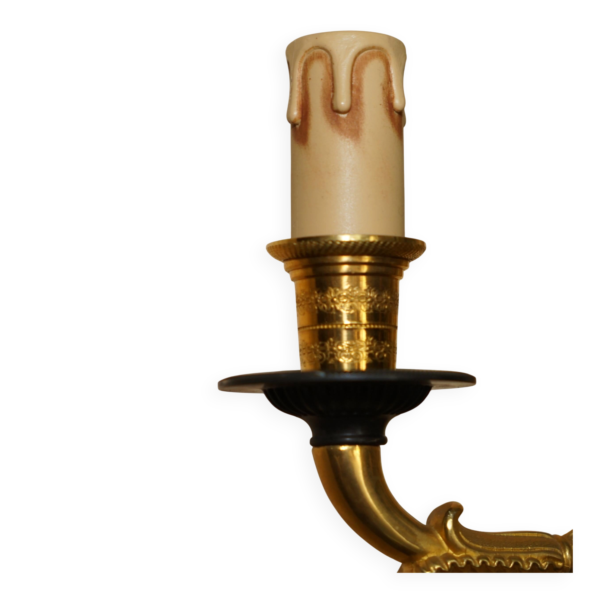 Pair of L'Originale wall sconces plated with 24-carat gold featuring four bronze candles.