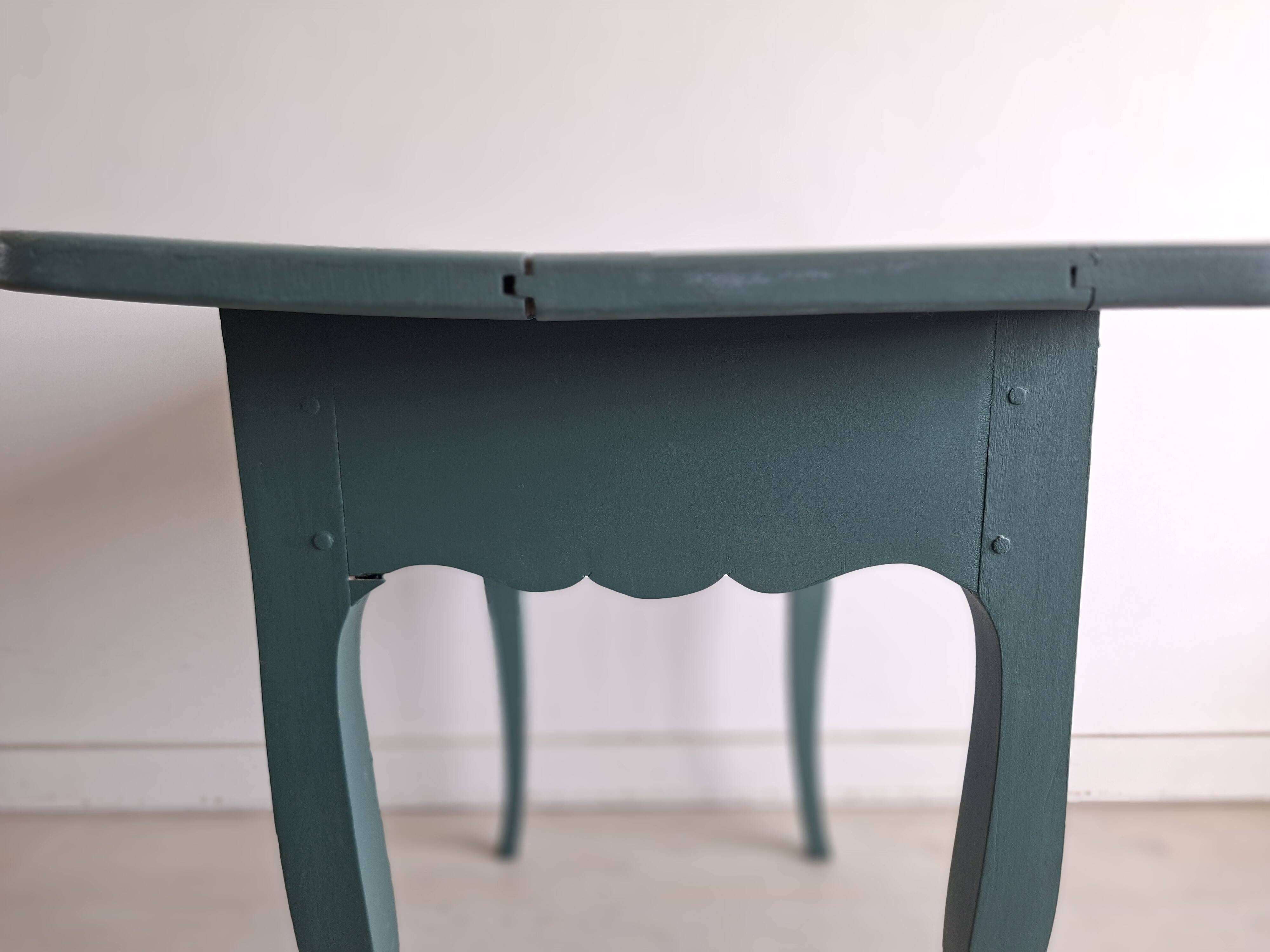 Antique Gustavian-style table painted in dark green with a drawer.