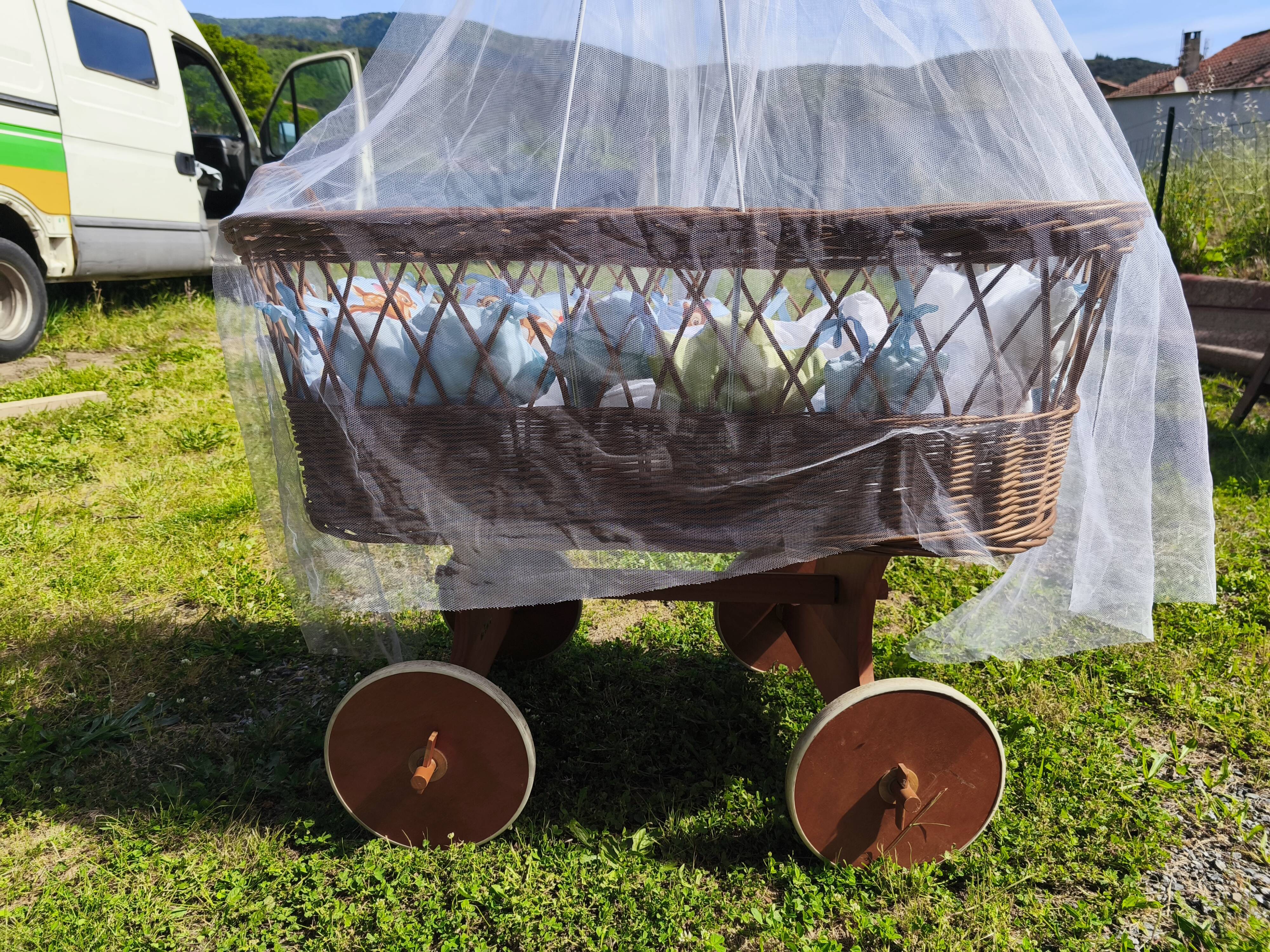 Vintage wicker cradle/pram on wheels