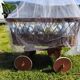 Vintage wicker cradle/pram on wheels