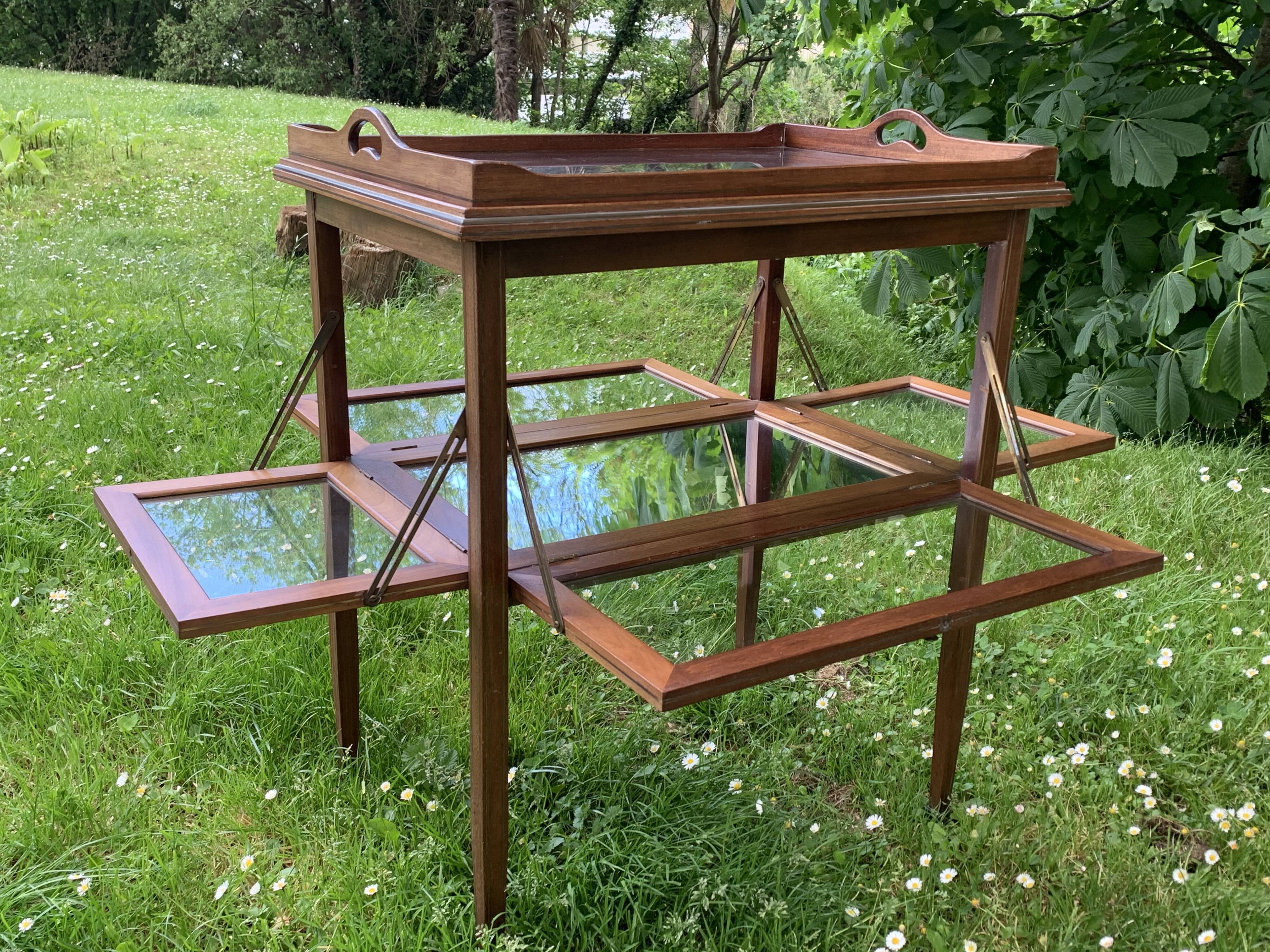 Glass-enclosed old tea table with wooden tray, bronze and brass