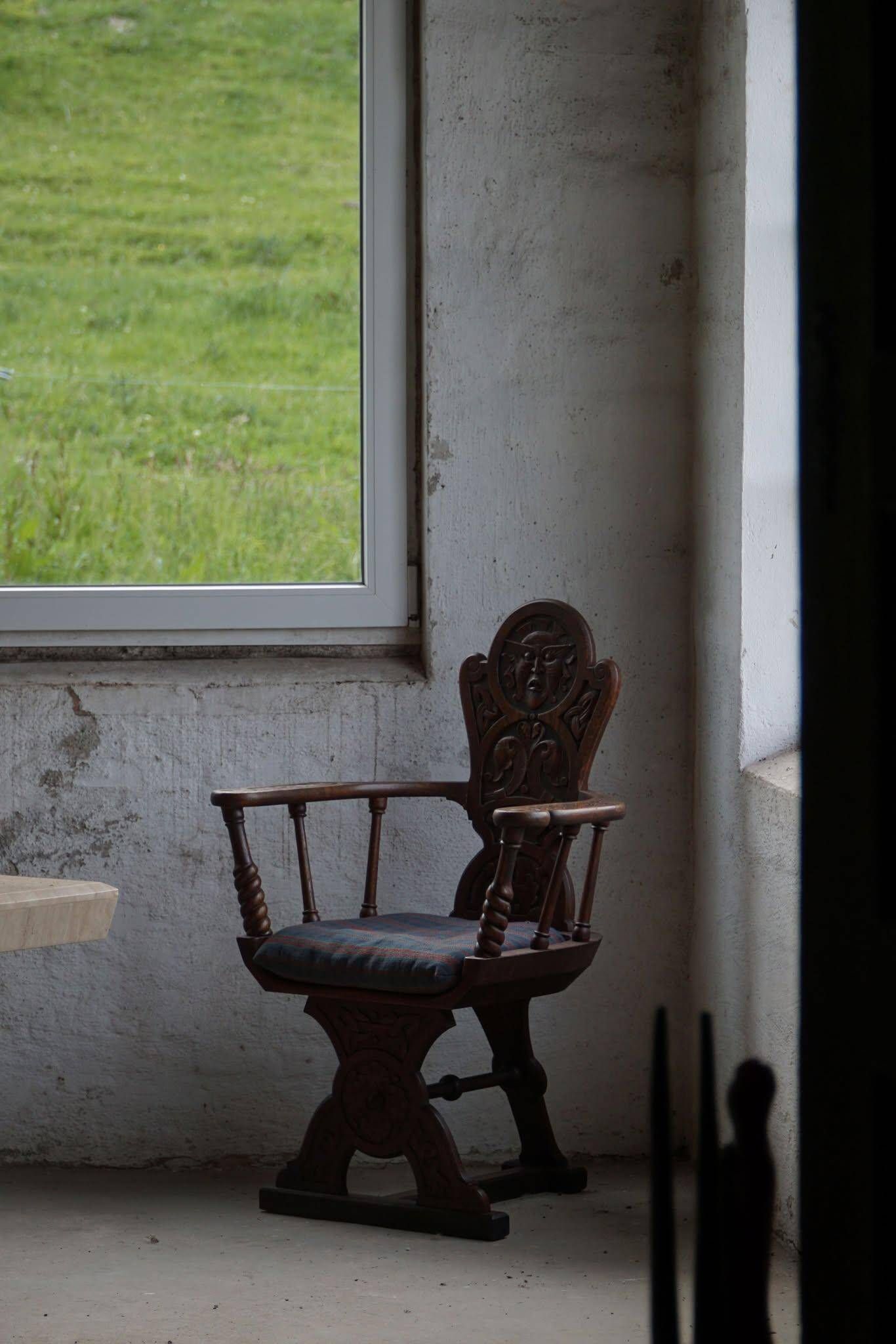 Scandinavian armchair in solid oak with cushion, folk art, early 19th century.