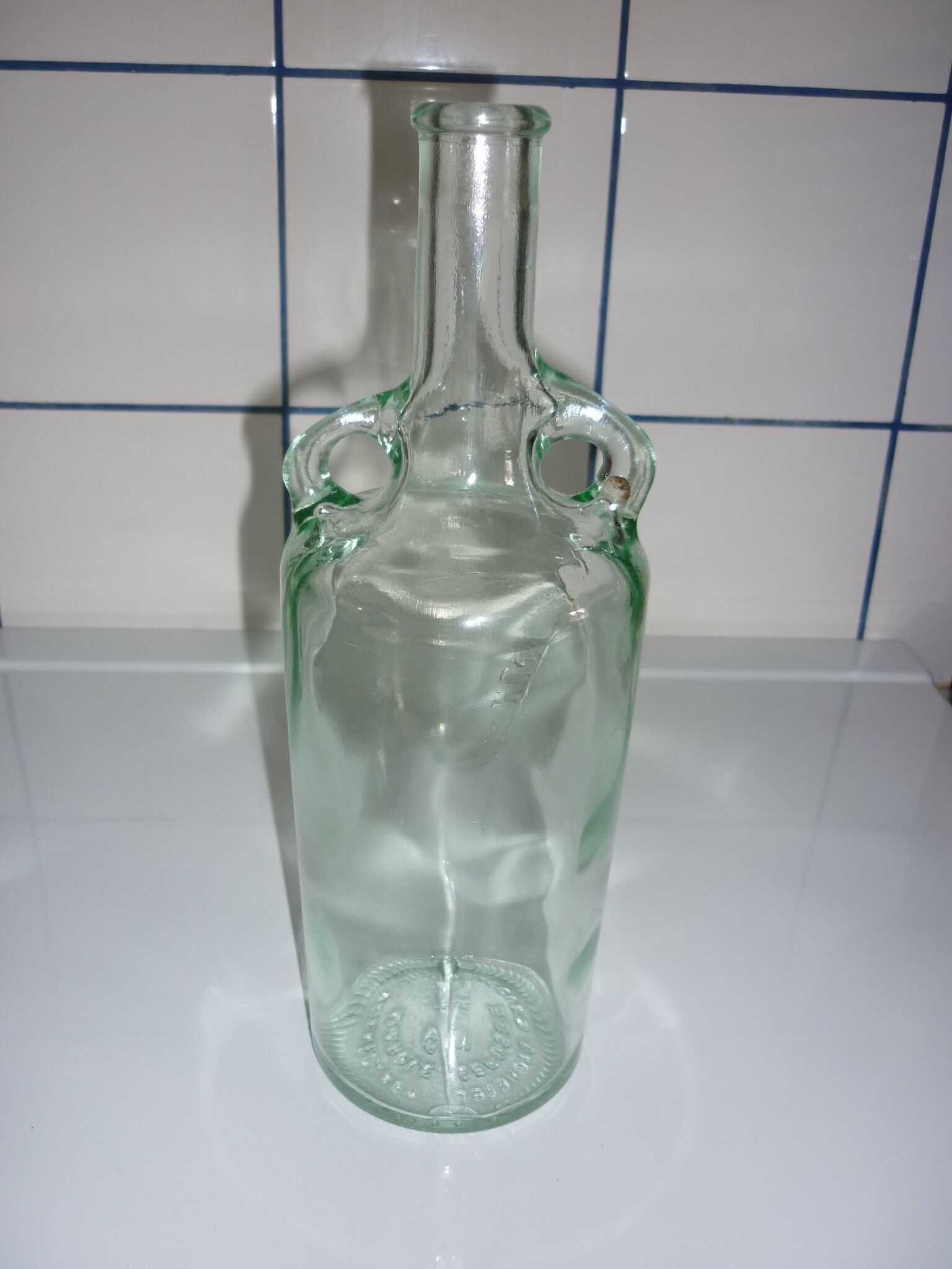 Old transparent moulded glass bottle