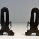 Pair of Modernist Andirons in Cast Iron with Openwork Uprights and Tripod Bases