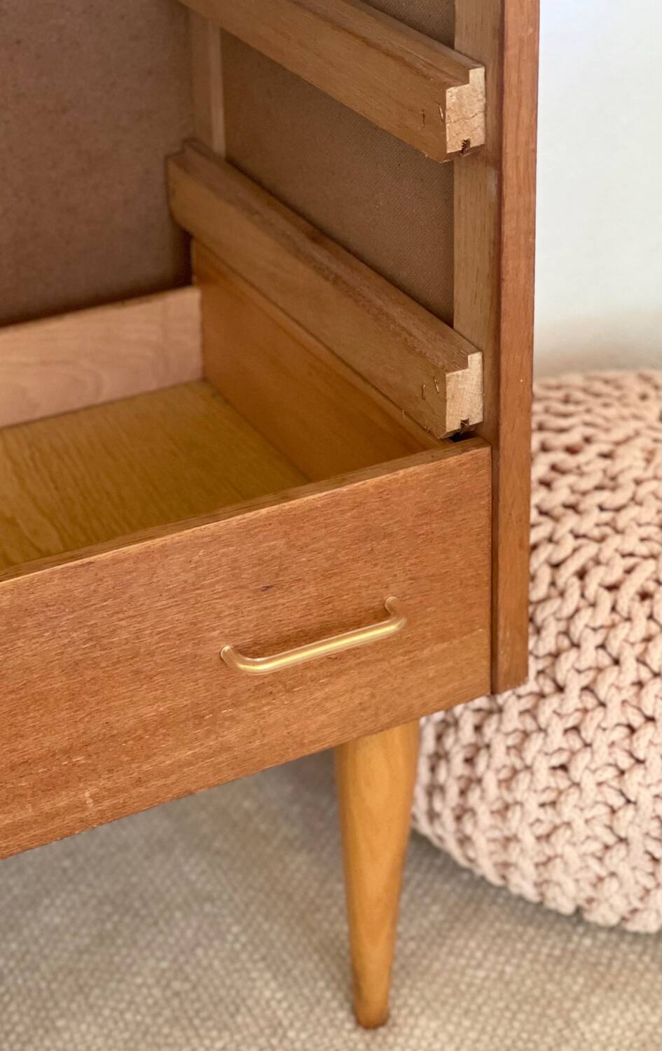 Vintage 1960s chest of drawers with covered handles.