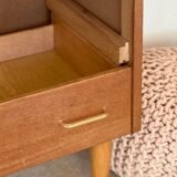 Vintage 1960s chest of drawers with covered handles.