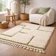 Beige Berber rug with a structured green abstract pattern.