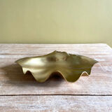 Large empty pocket in the shape of a golden brass shell
