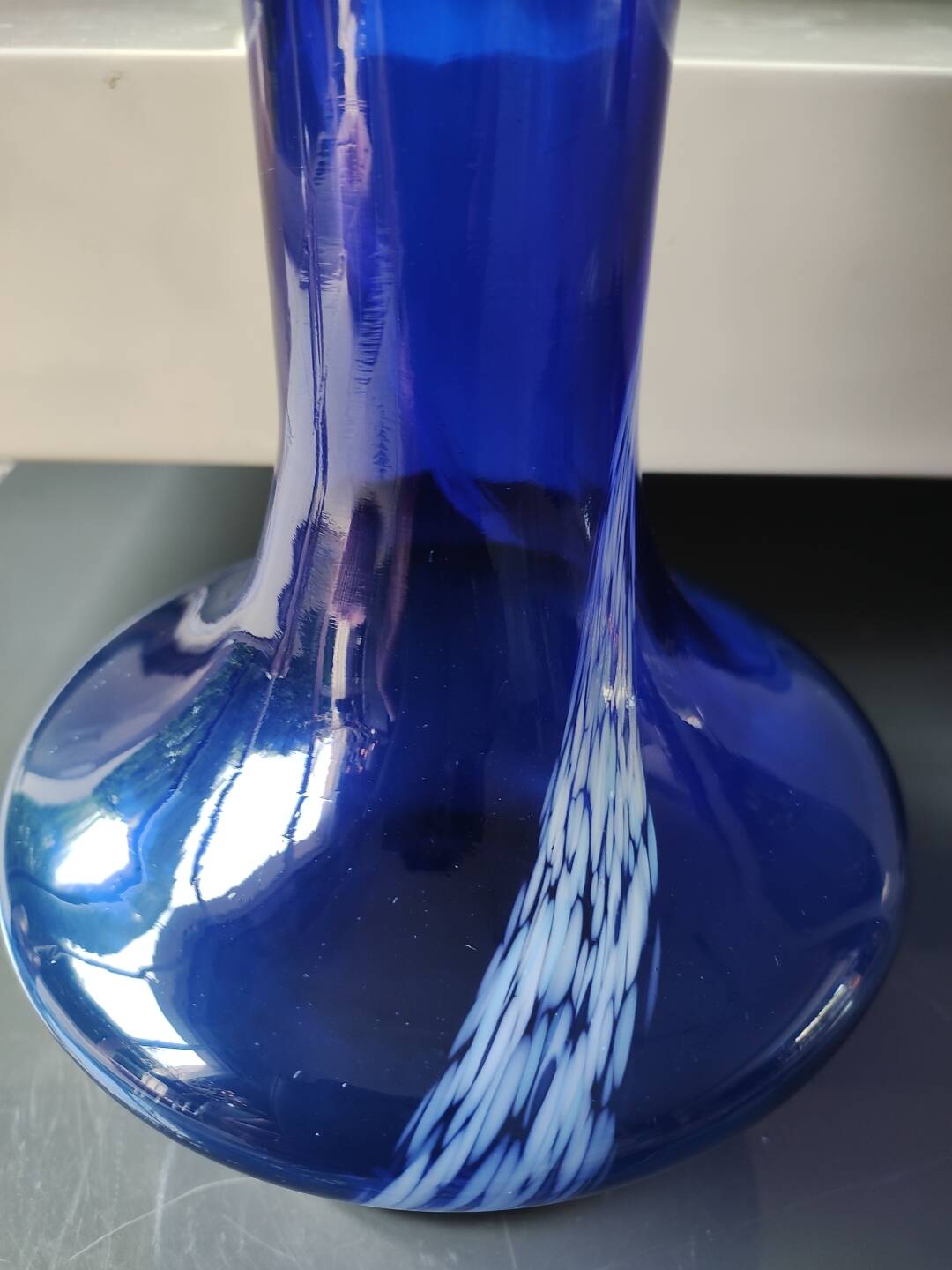 Long flared neck ball vase. Smoked scrolls in cobalt blue art glass, 30cm