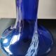 Long flared neck ball vase. Smoked scrolls in cobalt blue art glass, 30cm