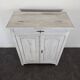 Small buffet with two doors and one drawer in white patinated wood.