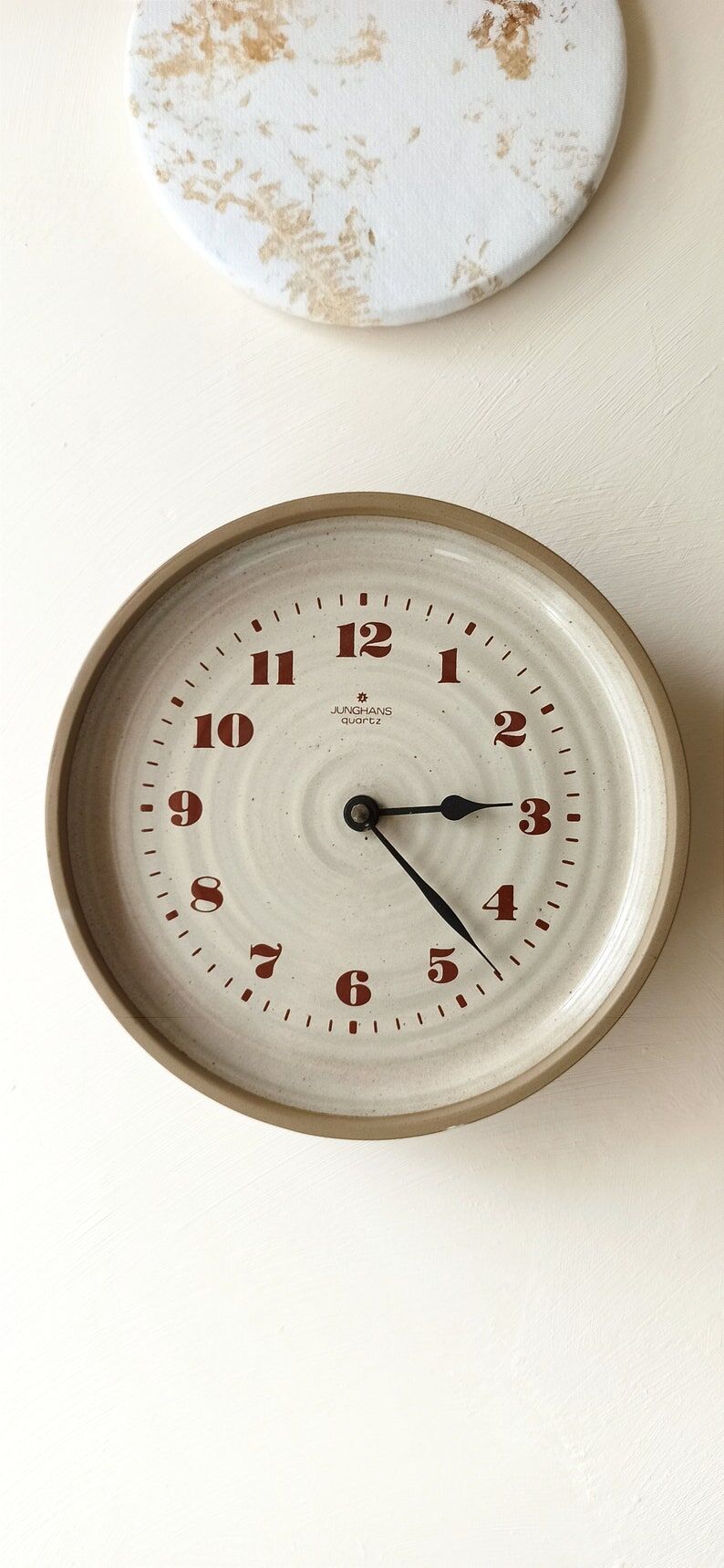Clock in the shape of a round plate Junghans