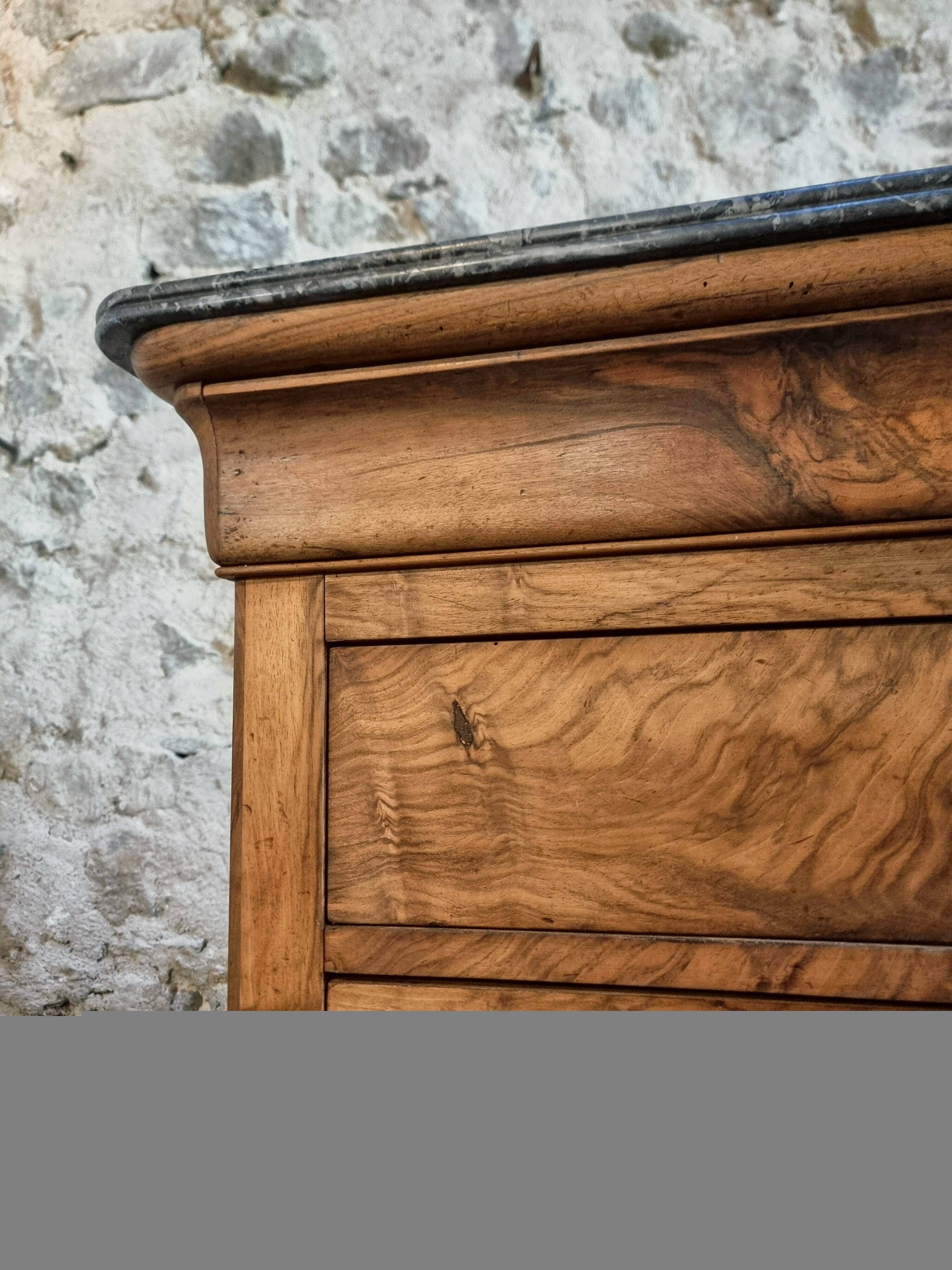 French antique walnut commode with a dark grey marble top, circa 1830–1860.