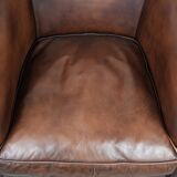 Great luxurious brown cowhide club armchair with matching piping
