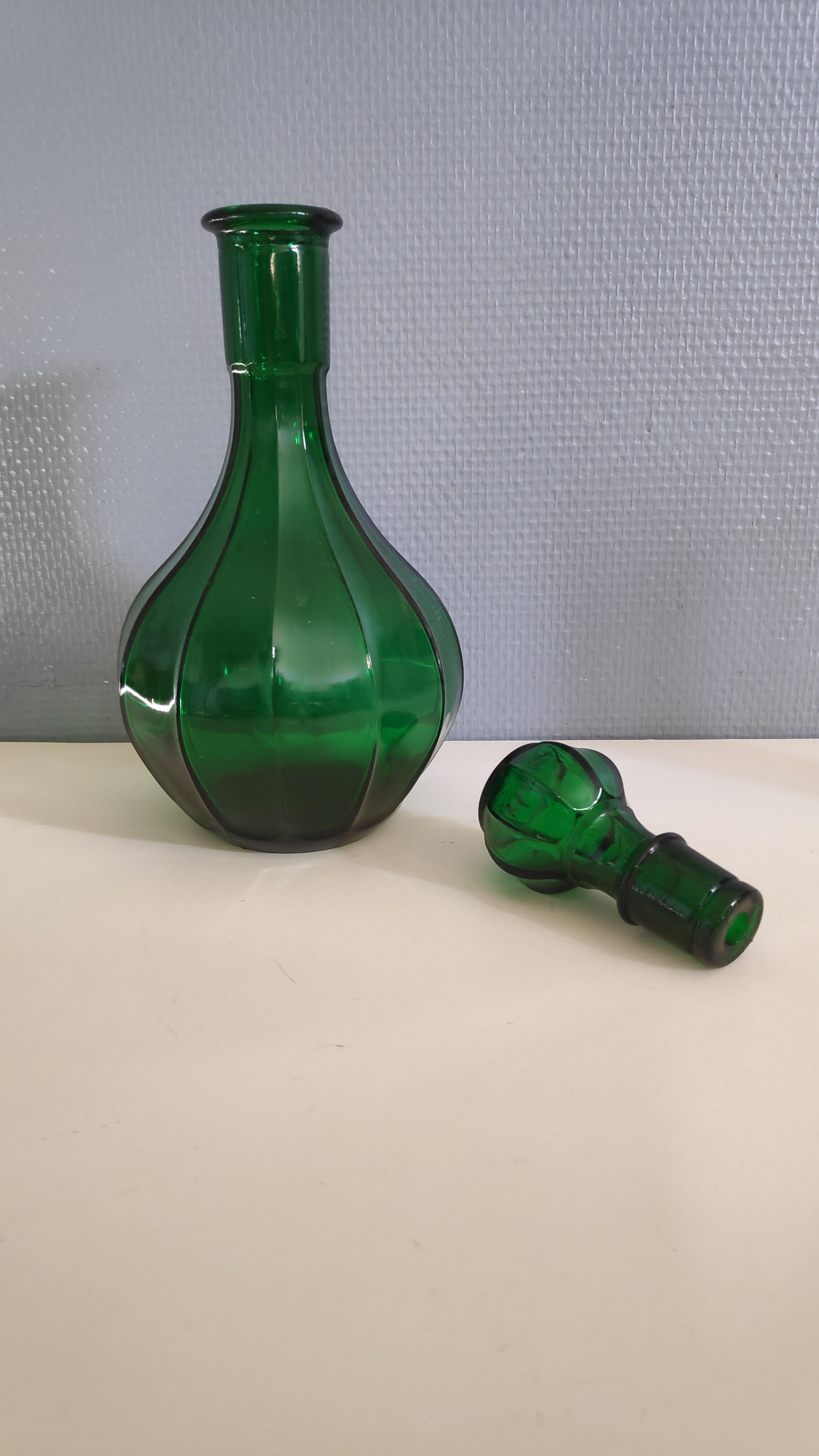 Old green carafe with ribbed lines