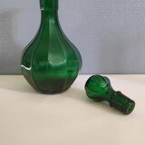Old green carafe with ribbed lines