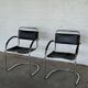 Vintage cantilever chairs in black saddle leather and chrome.
