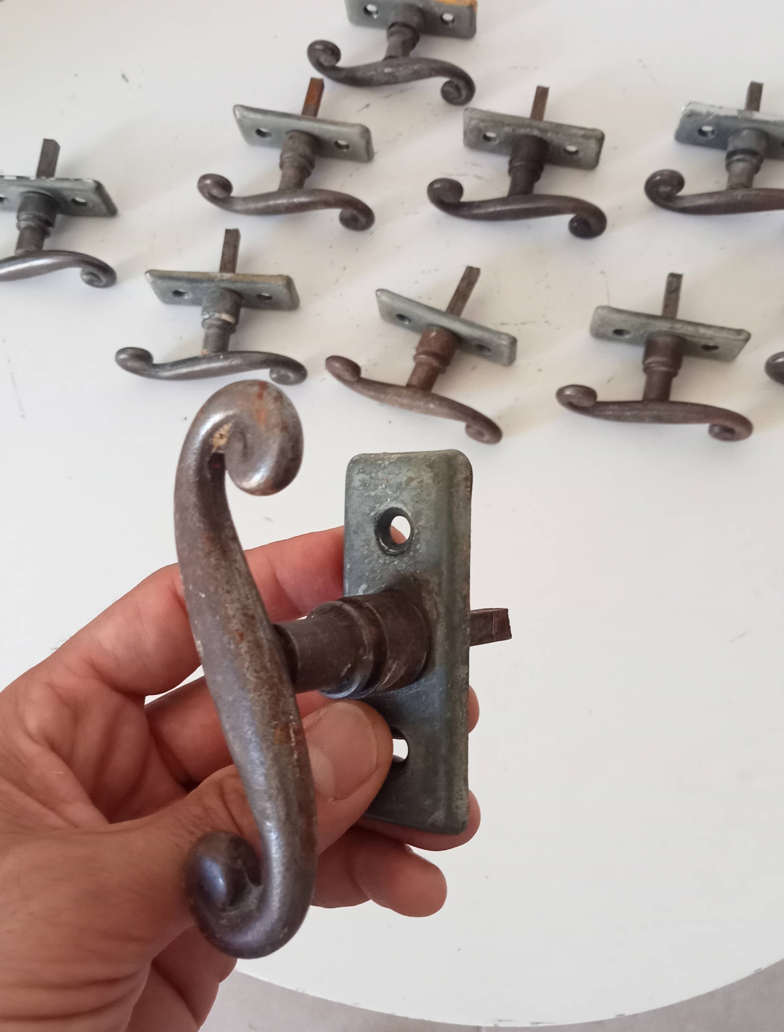Old window handle with a forged iron cremon.