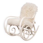 Antique Thonet rocking chair in ivory lacquered bent wood, with a white lamb fur seat.