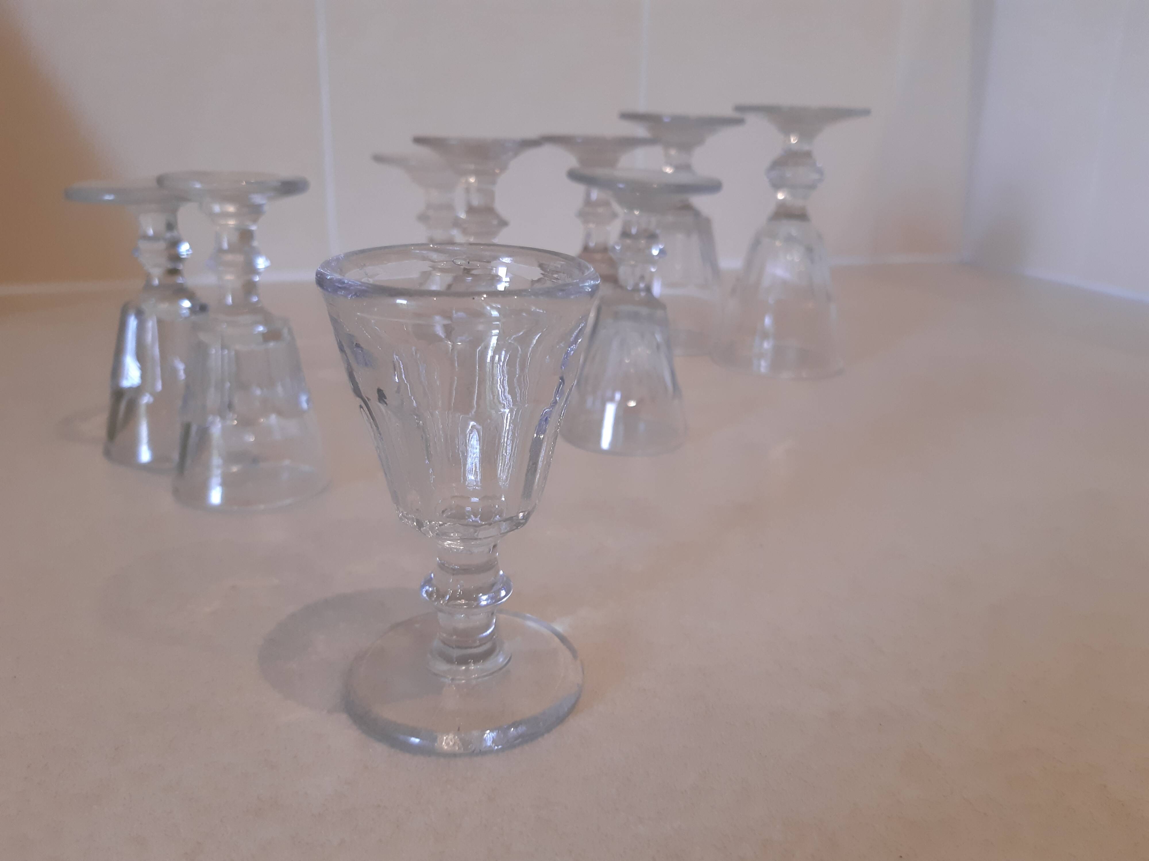 Set of 9 small cut glass stemmed glasses from the 1930s, in various sizes.